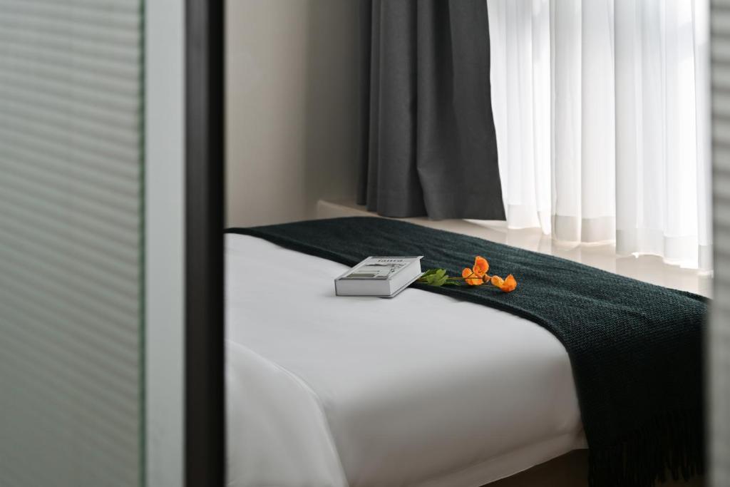 Postel nebo postele na pokoji v ubytování East Maple International Apartment - Guangzhou Luogang Wanda Plaza Suyuan Metro Station