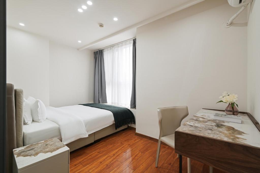 Postel nebo postele na pokoji v ubytování East Maple International Apartment - Guangzhou Luogang Wanda Plaza Suyuan Metro Station