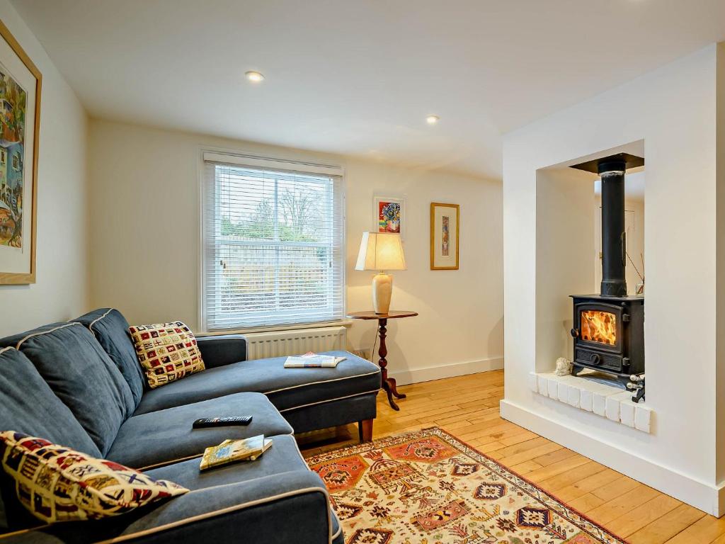 a living room with a couch and a fireplace at 2 Bed in Long Melford 81320 in Long Melford