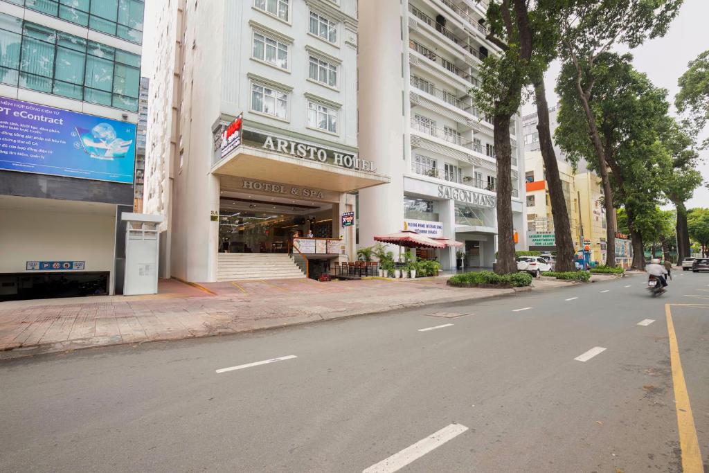 a person riding a motorcycle down a city street at Aristo Saigon Hotel in Ho Chi Minh City