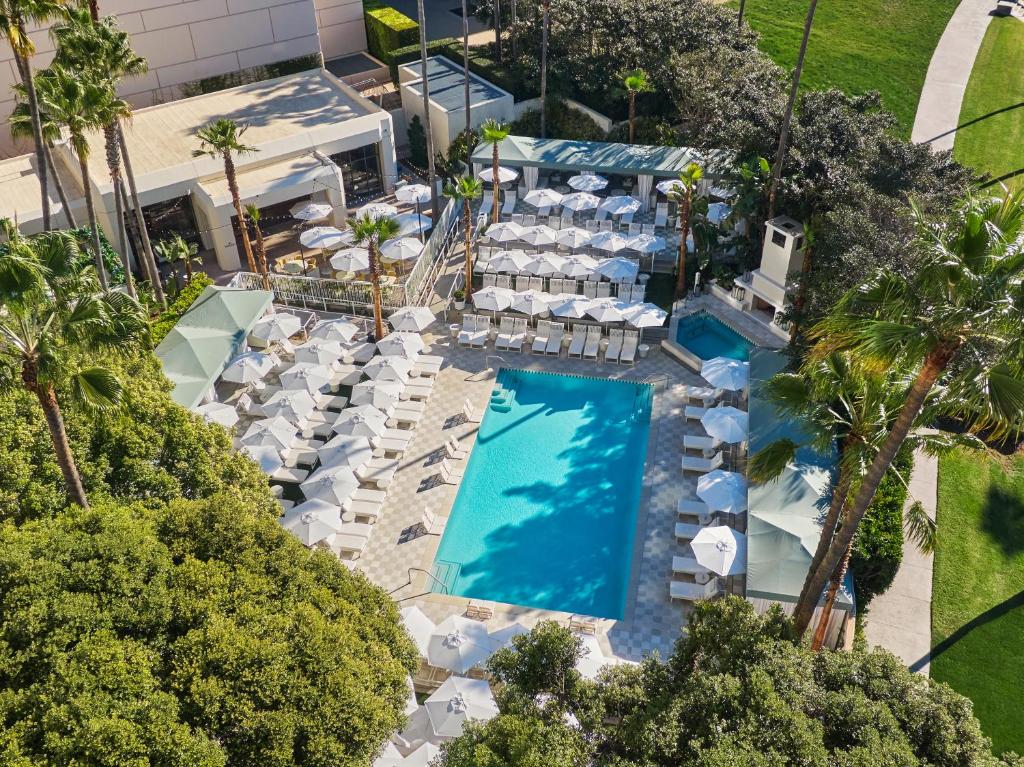 an overhead view of a pool with chairs and umbrellas at Pendry Newport Beach in Newport Beach