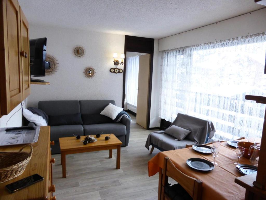 a living room with a couch and a table at Résidence Bel'aval - 3 Pièces pour 6 Personnes 364 in Les Contamines-Montjoie