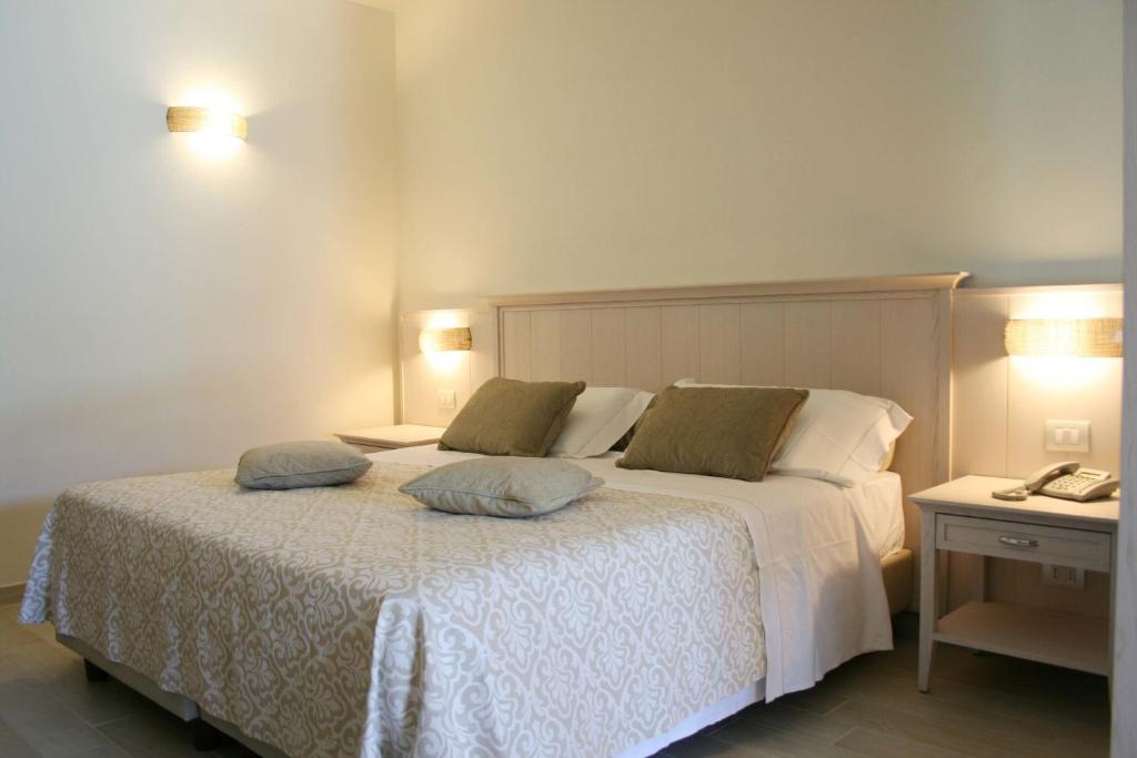 a bedroom with a bed with two pillows on it at Hotel Marana in Golfo Aranci