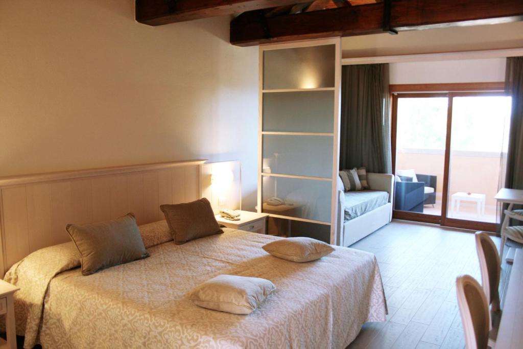 a bedroom with a bed with two pillows on it at Hotel Marana in Golfo Aranci