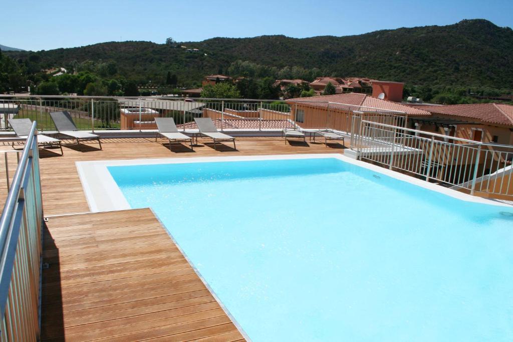 a large swimming pool on top of a building at Hotel Marana in Golfo Aranci