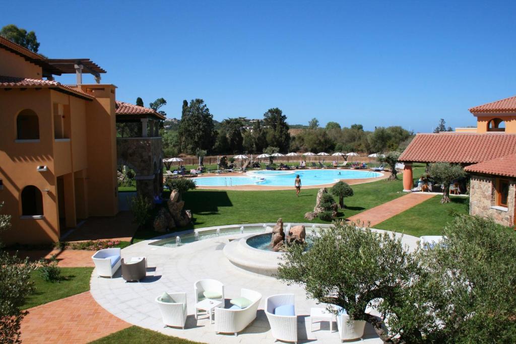 a resort with a swimming pool and lounge chairs at Hotel Marana in Golfo Aranci