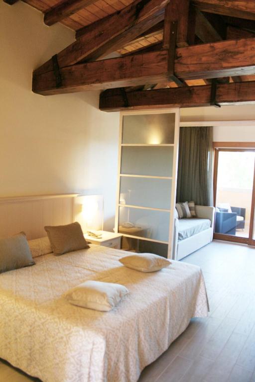 a bedroom with a bed with two pillows on it at Hotel Marana in Golfo Aranci