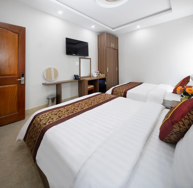Postel nebo postele na pokoji v ubytování ROMANCE HOTEL DALAT