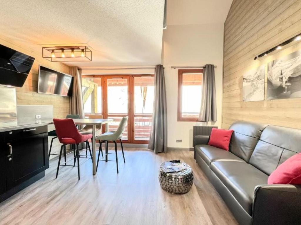 a living room with a couch and a table at Chalets Du Galibier I - Studio pour 4 Personnes 654 in Valloire