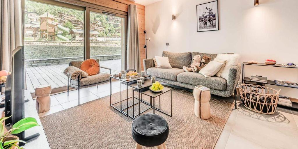 un salon avec un canapé et une table dans l'établissement Résidence Les Terrasses De La Vanoise - 3 Pièces pour 6 Personnes MAE-7214, à Champagny-en-Vanoise