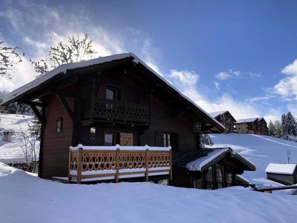 a log cabin in the snow with a balcony at Chalet Sarazin - Chalets pour 4 Personnes 994 in Crest-Voland
