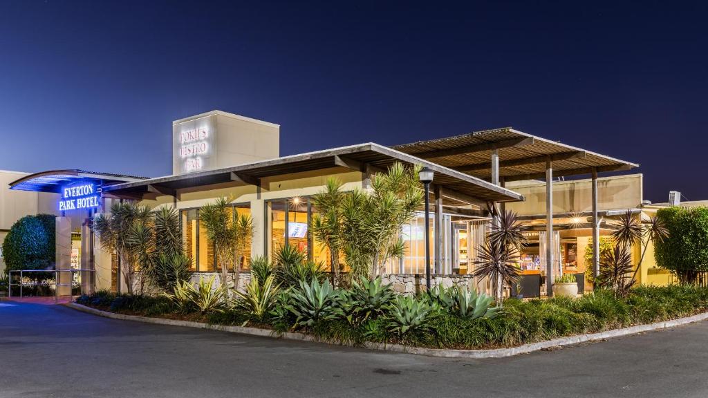 a building with palm trees in front of a building at Everton Park Hotel in Brisbane