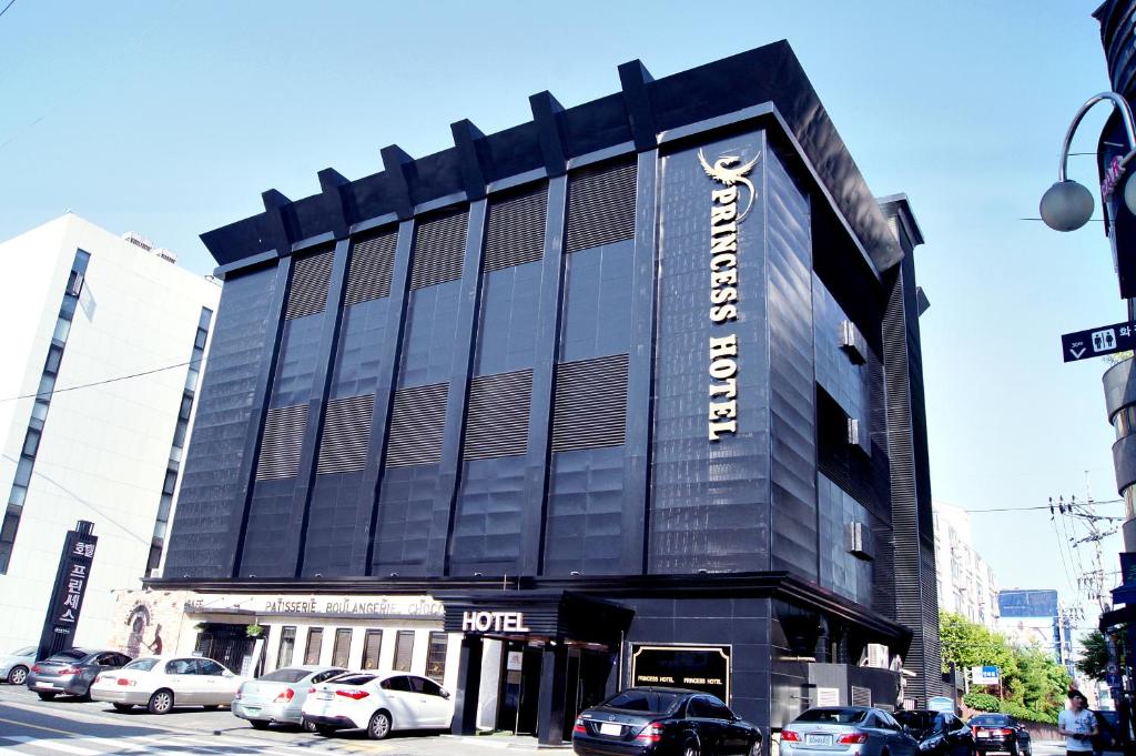 a large black building with cars parked in front of it at Princess Hotel in Seoul