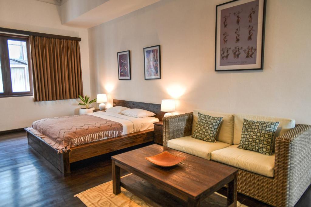 Postel nebo postele na pokoji v ubytování Melo Suites Hotel