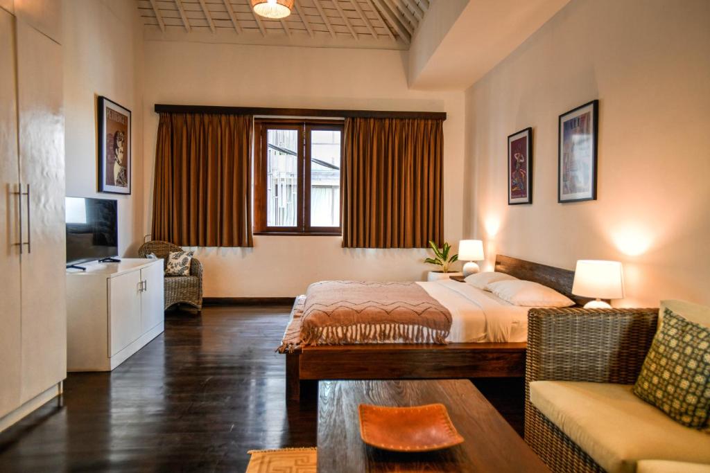 Postel nebo postele na pokoji v ubytování Melo Suites Hotel