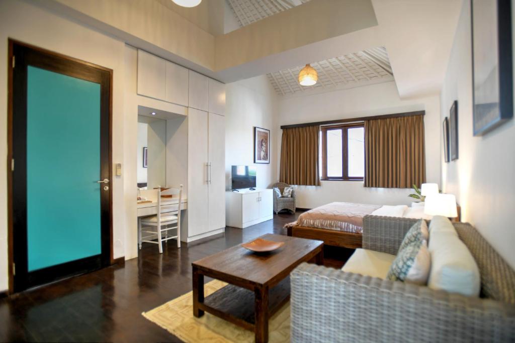 Postel nebo postele na pokoji v ubytování Melo Suites Hotel