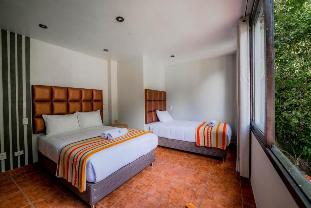 Postel nebo postele na pokoji v ubytování NaturaLodge Machu Picchu