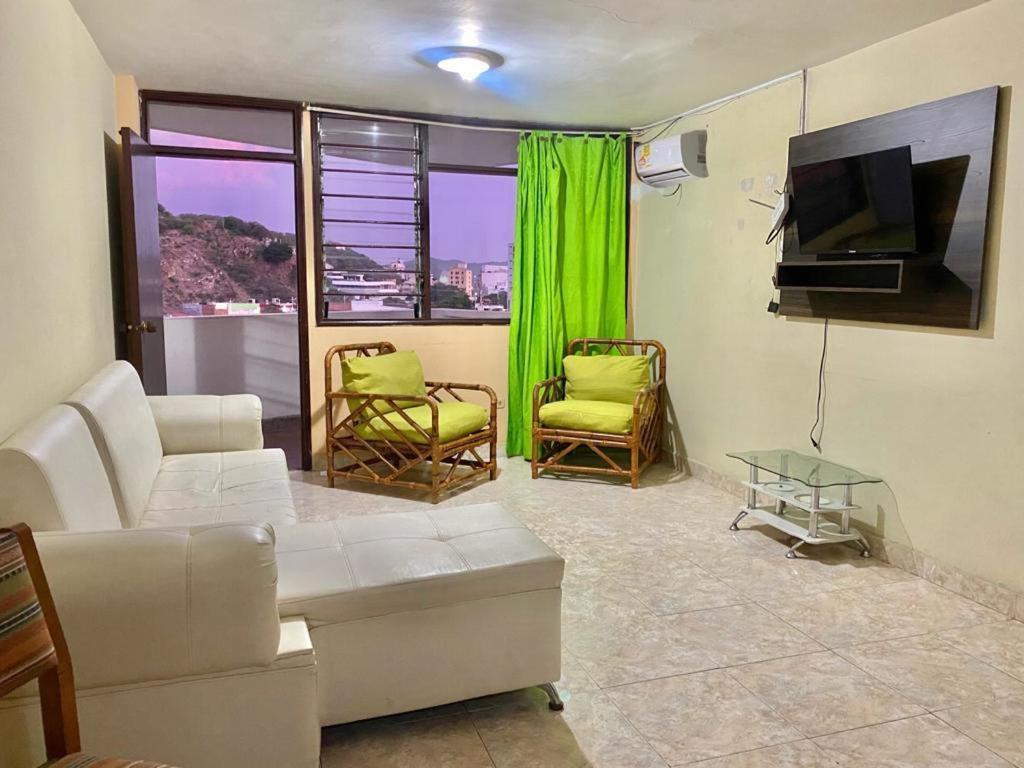 sala de estar con sofá, sillas y TV en Edificio Maratea Apt 704 El Rodadero en Santa Marta