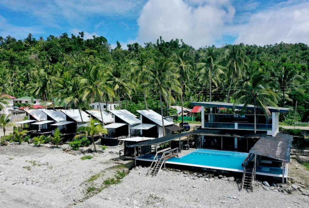 a house on the beach with a swimming pool at Surigao Dream Beach Resort in Tigbao