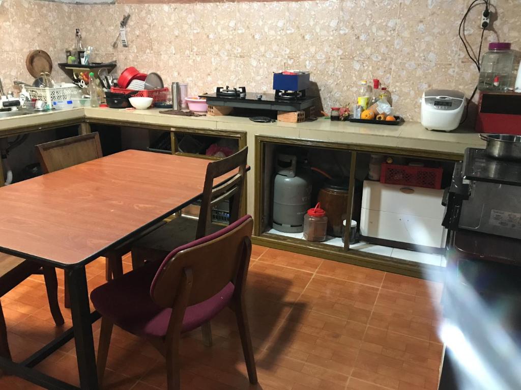a kitchen with a table and chairs in a kitchen at RosiesHome in Da Lat