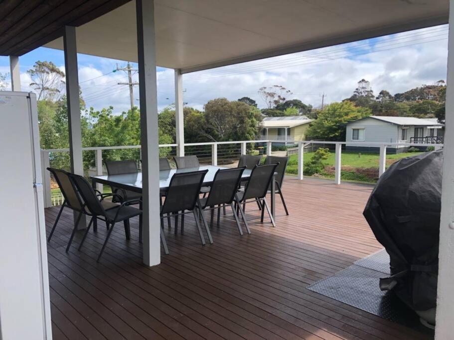a patio with a table and chairs on a deck at Coastal Retreat, 400 Metres to beach in Cowes