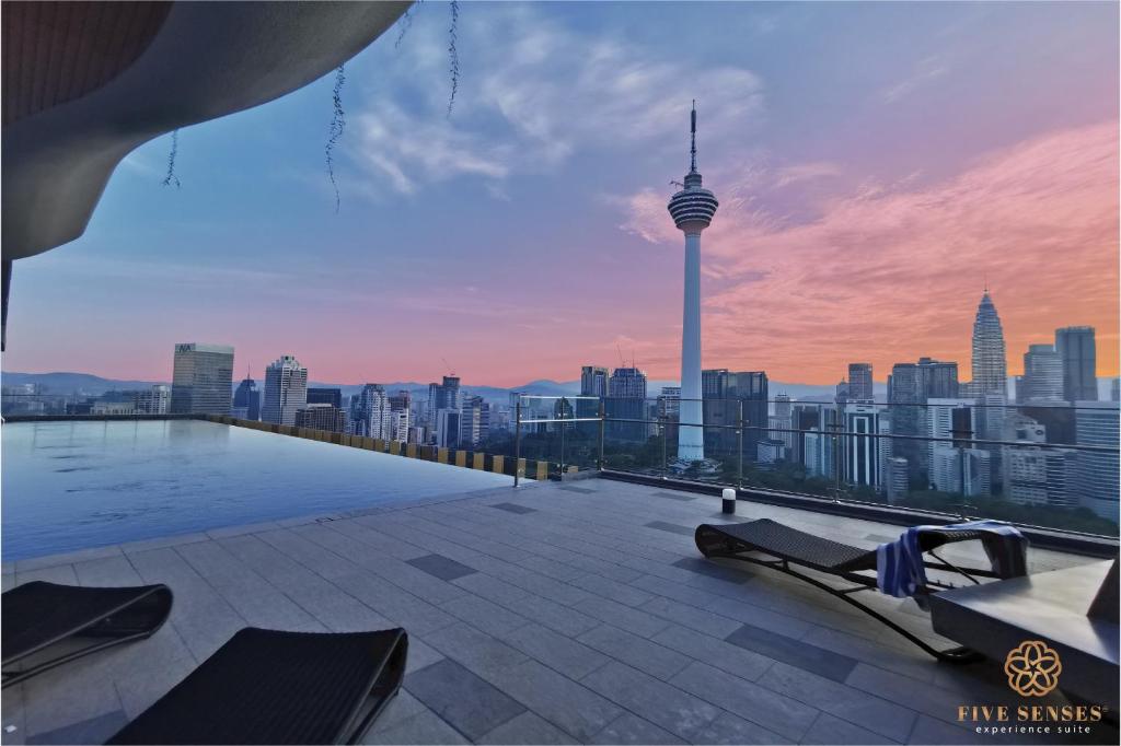 a rooftop swimming pool with a view of a city at Ceylonz Suite Kuala Lumpur Five Senses in Kuala Lumpur