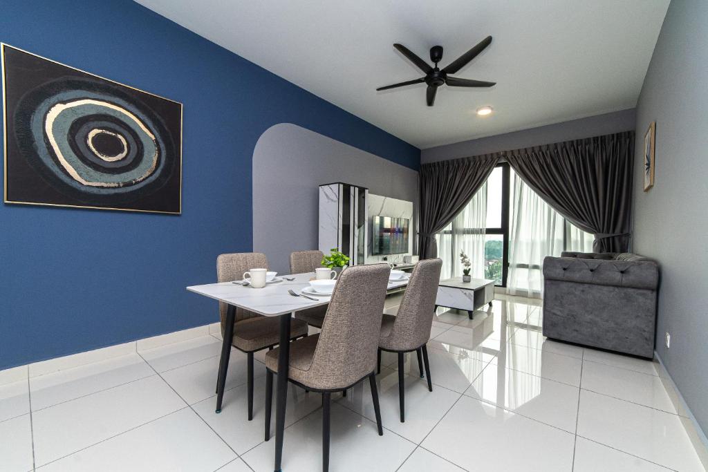 a dining room with blue walls and a table and chairs at Mosaic Southkey Marine Blue 2BR by Our Stay in Johor Bahru