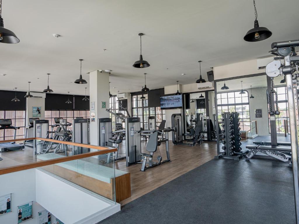 a gym with several treadmills and machines at Secana Beachtown Resort & Residences in Canggu