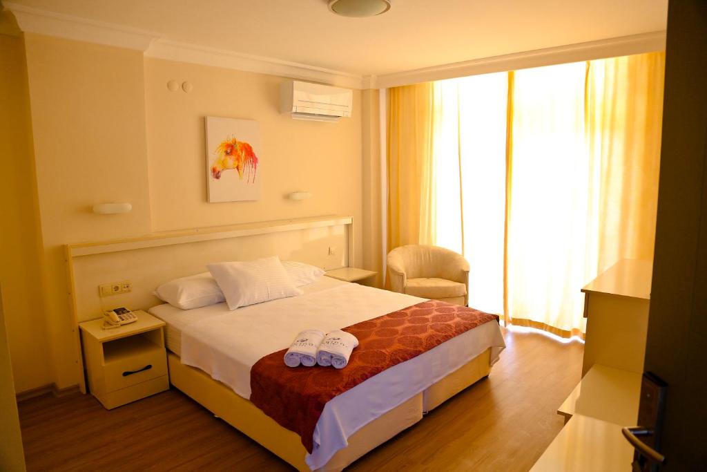a hotel room with a bed and a window at Nagidos Hotel in Bozyazı