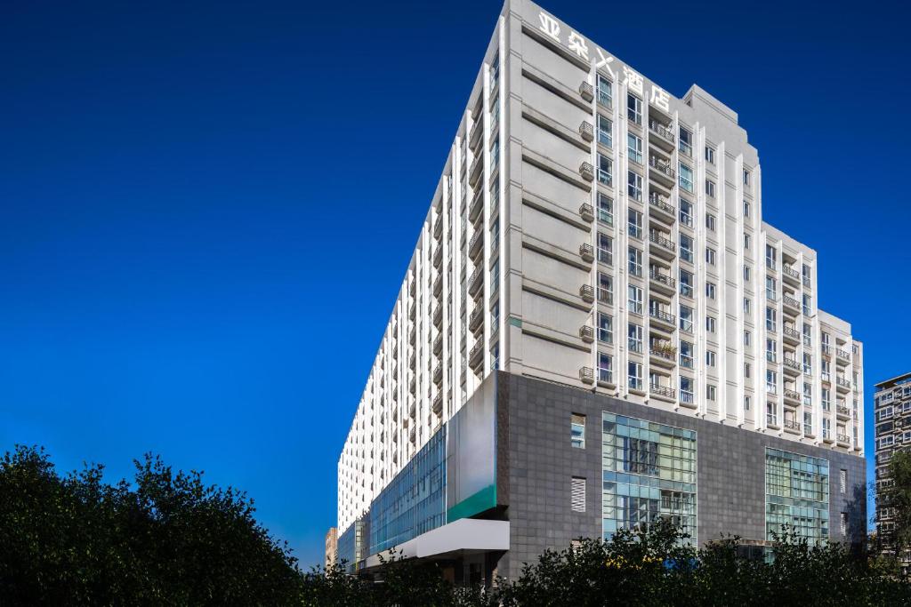 a tall white building with a blue sky at Atour X Hotel Beijing Haidian Sijiqing in Beijing