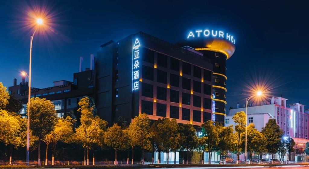 a building with a sign on top of it at Atour Hotel Kunming Dashanghui in Kunming