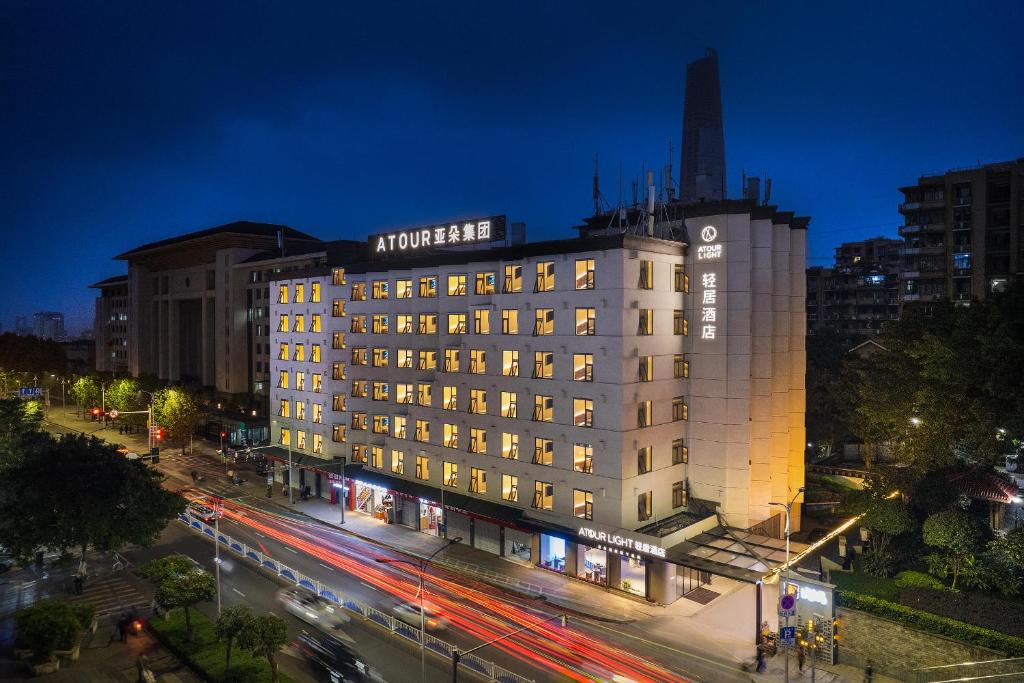 a lit up building in a city at night at Atour Light Hotel Chongqing Yuzhong Daping Metro Station in Chongqing