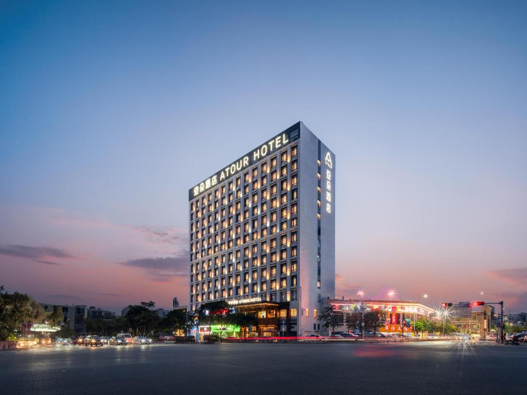 a tall building with lights on it at night at Atour Hotel Foshan Chancheng Zhangcha in Foshan