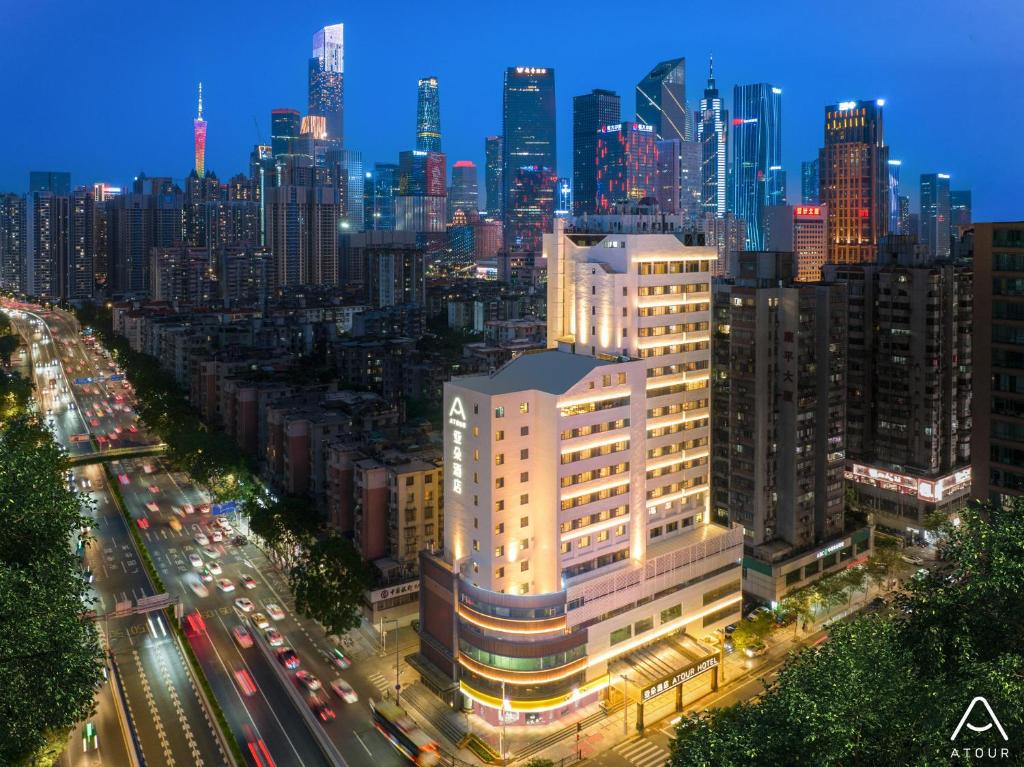 a view of a city skyline at night at Atour Hotel Guangzhou Zhujiang New Town Taikoo Hui in Guangzhou