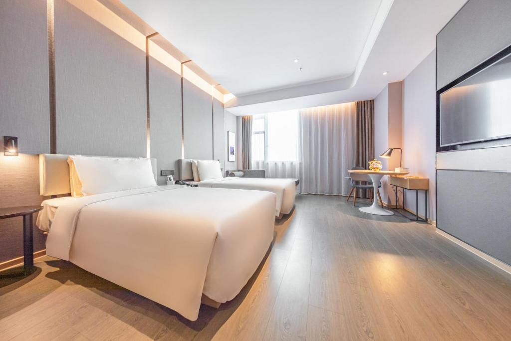 Postel nebo postele na pokoji v ubytování Atour Hotel Shenzhen Guangming New City
