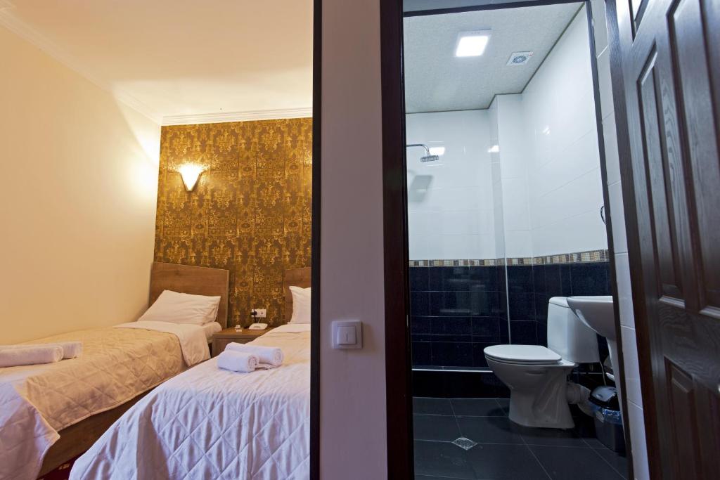 Postel nebo postele na pokoji v ubytování Orange Hotel