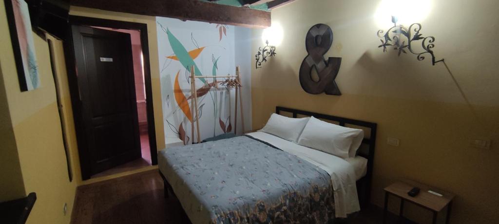 a bedroom with a bed and a painting on the wall at Agriturismo Corte dei Landi in Reggio Emilia