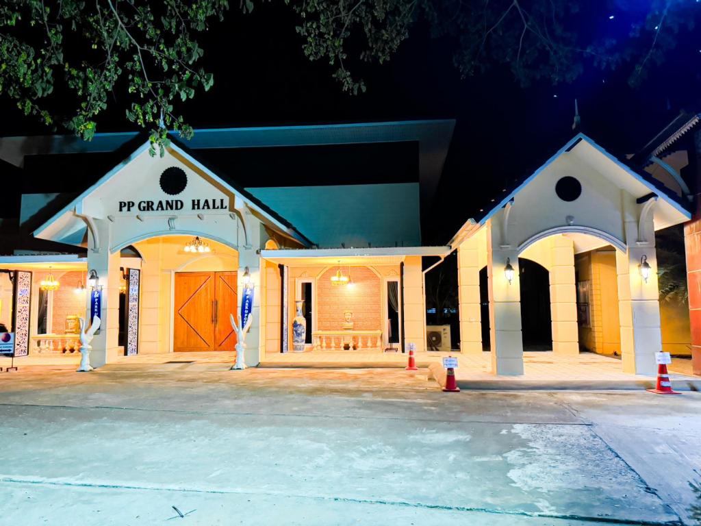 a building with a yard mall in the night at Park & Pool Resort in Nong Khai