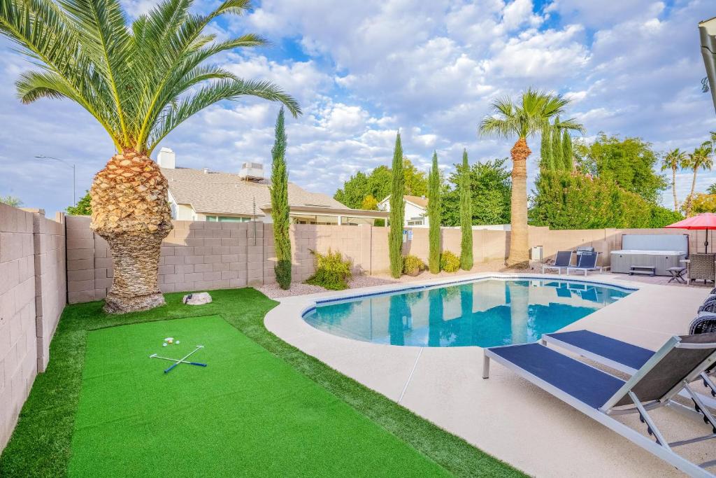 a backyard with a swimming pool and a palm tree at Scottsdale Vacation Rentals in Scottsdale