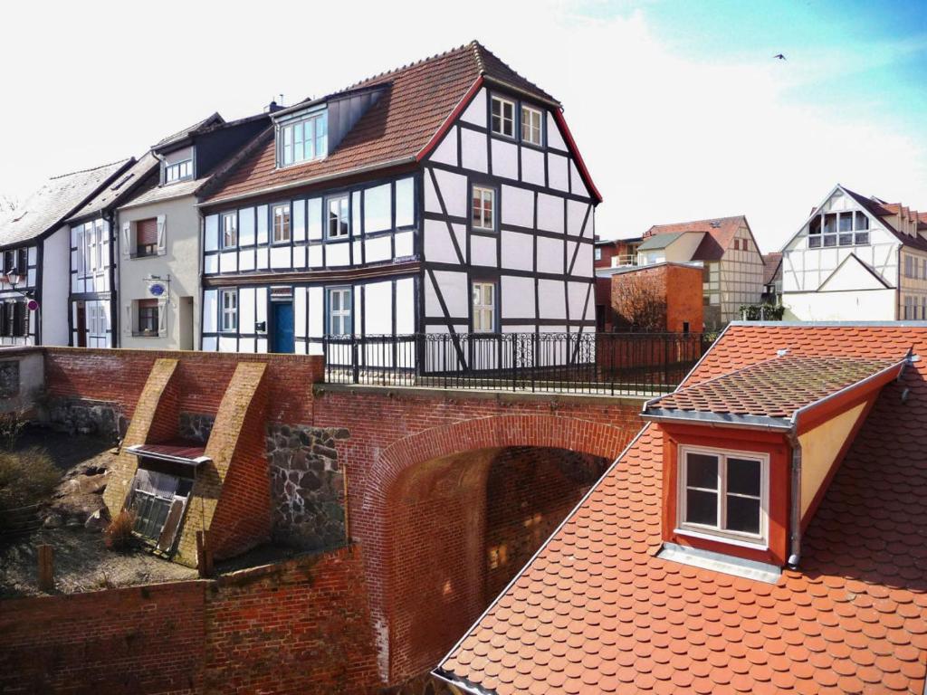 a black and white building with a bridge at Haus zur Eselsbrücke in Tangermünde