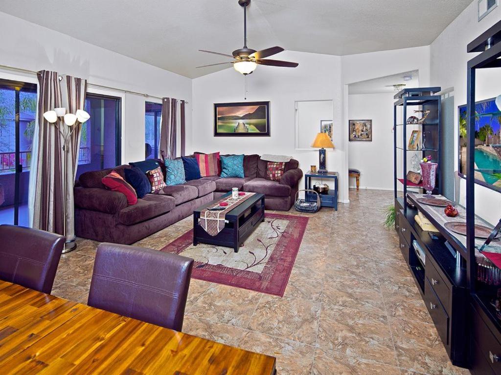 a living room with a couch and a tv at Central Location, Heated Pool, Bbq, Hot Tub, More in Scottsdale