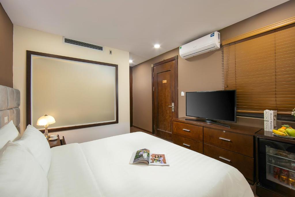 Postel nebo postele na pokoji v ubytování Brilliant Me Tri Hotel & Spa