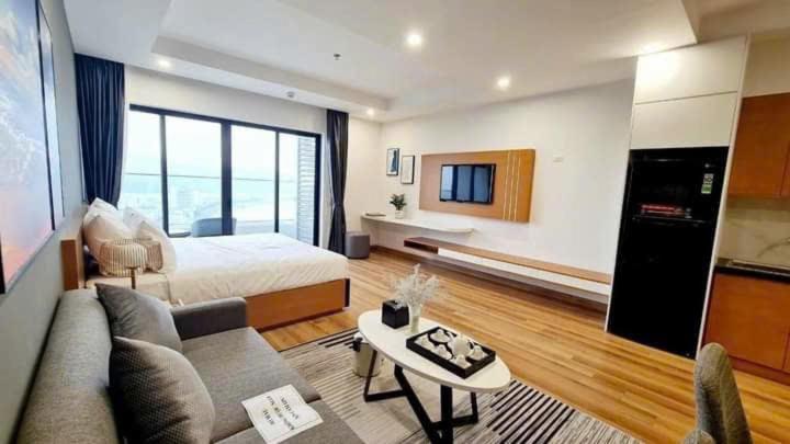 a living room with a bed and a couch at Căn Hộ TMS Luxury Apartment - Condotel Quy Nhơn in Quy Nhon