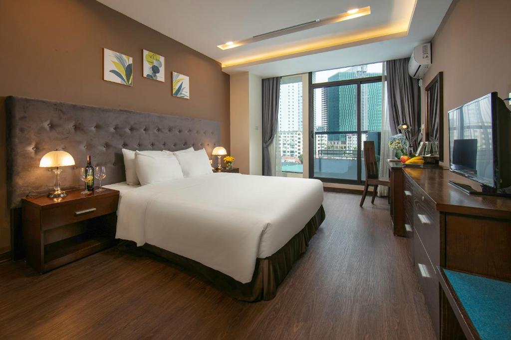 Postel nebo postele na pokoji v ubytování Brilliant Me Tri Hotel & Spa