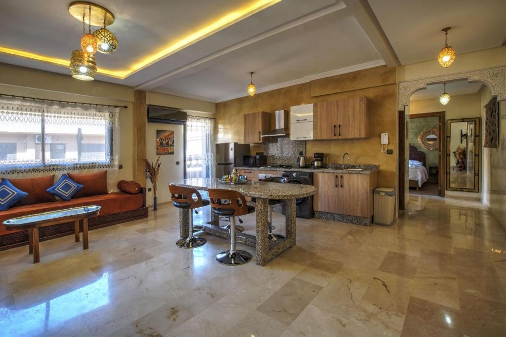 a large kitchen with a table and a couch at Nour 5 el bellar in Marrakesh
