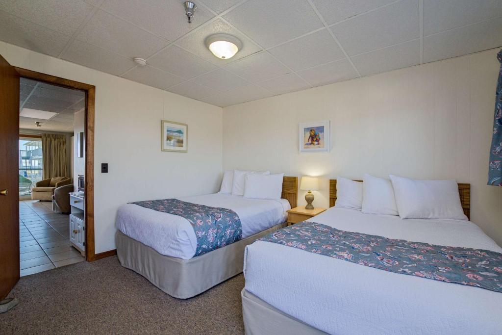 a hotel room with two beds and a hallway at Kebek 3 Motel in Old Orchard Beach