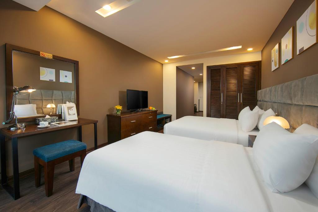 Postel nebo postele na pokoji v ubytování Brilliant Me Tri Hotel & Spa