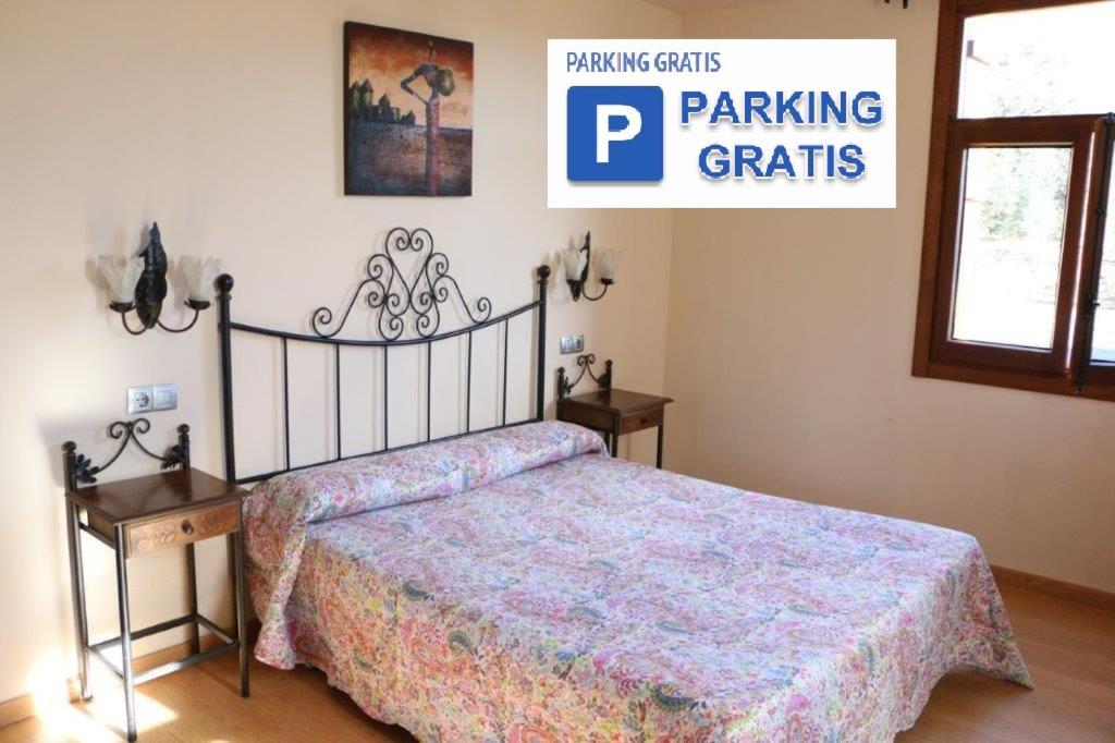 a bedroom with a bed and a sign for parking gratiates at Pensión Ametzagaña in San Sebastián