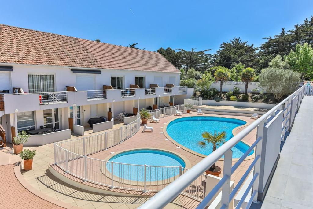 a balcony view of a hotel with two pools at Résid'Azur - T2 résidentiel avec piscine in Saint-Jean-de-Monts