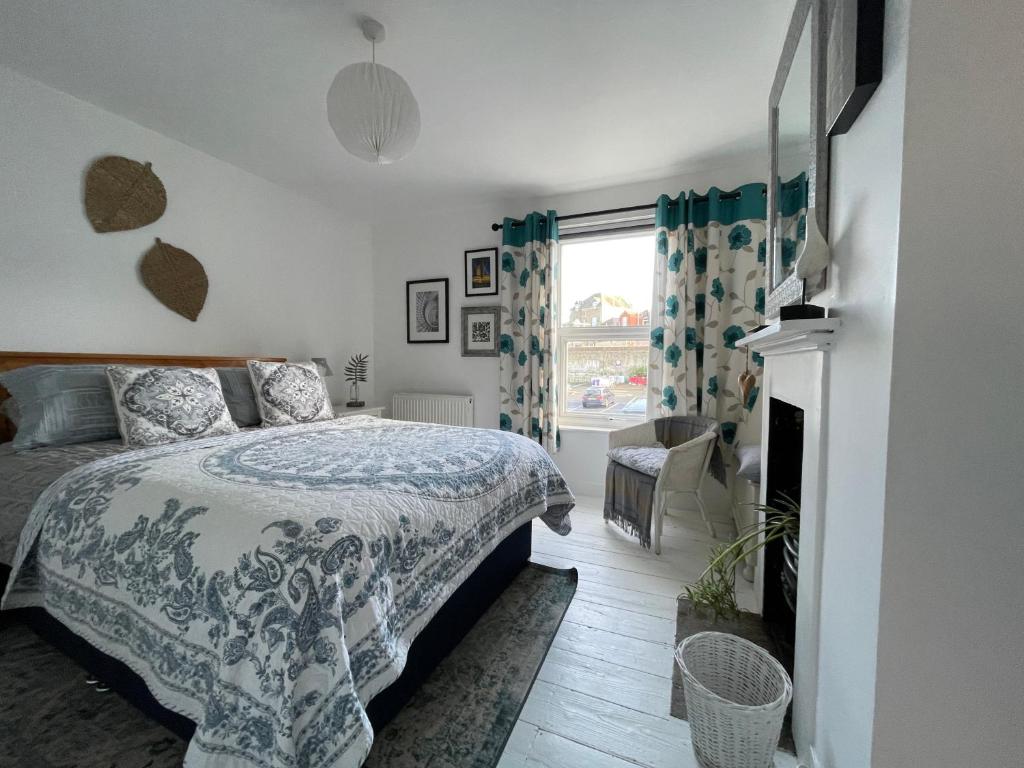 ein Schlafzimmer mit einem Bett und einem Kamin in der Unterkunft No 28 Sleeps 4 in the heart of Cowes in Cowes